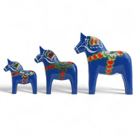 Grannas A. Olsson Hemslojd(グランナス オルソン ヘムスロイド)は、1922年にスウェーデン・ダーラナ地方ヌスナスで創業した世界最古のダラホース工房です。創業者のアンダース オルソン氏は、当初家族経営のパン屋から木工品製造へと転換し、弟らと協力してダラホースの生産を始めました。ひとつずつ選別されたスロースギ材(シルヤン湖周辺の赤松)を使い、木型の挽きから手彫り、下地塗装、さらに熟練のリップル(波模様)ペインターによるフリーハンド装飾を施します。その後、丁寧にニス仕上げされ、赤や白、青など伝統色に彩られた馬たちは、まさに「スウェーデンの象徴」として世界中の家庭や店舗に愛されています。伝統工房としての格式を受け継ぎつつも、パステルやモノトーン、限定柄などを加えることで、現代のインテリアにもマッチするデザイン性も追求しています。