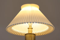 Gunnar Biilmann Petersenが1960年代にLe Klintのためにデザインしたこの「model 344 Telescope」は、独自の伸縮式高さ調節機能が特徴です。望遠鏡という名前は、ビルマン・ピーターセンがこのモデルに採用した、伸縮可能な高さ調節装置に由来しており、空間に応じた高さ調整が可能で、柔らかな光を提供します。さらに、この照明の真鍮製のベースが特に印象的で、重厚感と洗練された美しさを感じさせます。オリジナルのLe Klintシェードが付属しており、全体として北欧デザインの機能性と美しさが調和した貴重なアイテムです。