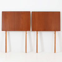 Ejner Larsen & Aksel Bender Madsenが手掛け、Naestved Mobelfabrikで製作されたエクステンションダイニングテーブルは、チーク材の天板とオーク材の脚部を組み合わせた北欧ビンテージらしい上質な佇まいが魅力です。直線的で端正なフォルムの中に、天板縁の丁寧な面取りや幕板の滑らかな造形など、当時の高い職人技が随所に感じられます。幅120cmから最大230cmまで伸長可能な構造により、日常使いから来客時まで柔軟に対応でき、空間や人数に合わせた使い方が可能です。経年変化によって深みを増した木肌の表情が、長く愛用されてきたビンテージならではの存在感を放ち、ダイニングの主役として落ち着きと品格を添えてくれる一台です。脚先には床へのダメージや汚れを防ぐためにチーク材がジョイントされており、実用性を考慮した当時の設計思想がうかがえます。また、裏面には「SKM」の刻印が確認でき、スウェーデン軍(Svenska KrigsMakten)の備品として使用されていたことを示す、背景のある希少な個体です。