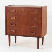 北欧ビンテージらしい温もりを感じさせるこちらの4段チェストは、上質なチーク材を使用したデンマーク製の一台です。無垢材を削り出したような立体感のある取手がアクセントとなっており、シンプルながらも丁寧な造りが際立ちます。幅70cmと程よいサイズ感で、寝室やリビングの収納としてはもちろん、玄関先の小物整理にも活躍します。使い込むほどに深まる色艶や木目の味わいも魅力のひとつです。