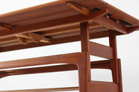 Kai Kristiansenデザインのエレベーターテーブルは、デンマークの名工Trioh moblerによって手作りされたシンプルで滑らかなデザインの逸品です。このテーブルは環境に応じて大きさを変えることができるため、デンマークではスタンダードアイテムとなっています。天板を片側だけ広げたり、高さを調整したりと、非常に機能的です。こちらは天板下に棚がある珍しいタイプです。1960年代にデザインされたものですが、丁寧にメンテナンスを行っているため長くお使いいただけます。