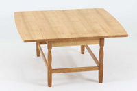 デンマークの建築家Henning Kjaernulf(ヘニング・ケアヌルフ)によってデザインされた、オーク無垢材のドロップリーフ式センターテーブルです。製造は高品質な家具で知られるEGモブラー社。無垢材ならではの美しい木目と、クラシカルで彫刻的な脚部のラインが印象的です。天板は両側に開閉式のリーフが備わっており、来客時や作業時には広げてスペースを拡張できるなど、実用性も兼ね備えています。テーブルの高さはやや高めの設計で、ソファ前に置いても手元が使いやすく、センターテーブルとして快適にお使いいただけます。必要に応じてサイドテーブルやティーテーブルとしても活躍する、用途の広い一台です。