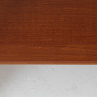 Hans J. Wegnerがデザインし、Andreas Tuck社から発表されたAT33ソーイングテーブルは、チーク無垢材を贅沢に用いた希少なモデルです。両側のバタフライ式天板で作業スペースを拡張でき、仕切り付きの引き出しとラタン製バスケットが裁縫道具や小物を美しく収納します。下段の棚板も備えた実用性の高い構造で、繊細な造作と職人技が光る北欧ビンテージ家具の逸品です。