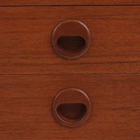 デンマーク製の小ぶりな北欧ビンテージボードで、チーク材とオーク材の組み合わせが上品な一台です。幅90cmとコンパクトながら、引き出し4杯とスライド扉付きの収納部を備え、実用性に優れています。丸いくり抜きの取っ手や直線的な脚部のデザインが軽快な印象を与え、どんな空間にも馴染みやすい造りです。背面の収納部には配線用の穴があり、オーディオや小型テレビ台としても活用可能です。経年により深みを増した木肌が、北欧家具ならではの味わいを感じさせます。