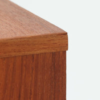 チーク材の美しい木目が前面に現れた、デンマークで作られた4段チェストです。直線を基調とした端正な佇まいと、引き出し上部に取手を設けたミニマルな構造が北欧らしい洗練を感じさせます。脚部は細身で床からの抜け感があり、空間を軽やかに演出します。収納力の高い4段構成で、衣類や書類、小物整理まで幅広く対応し、リビングや寝室、書斎など多様なシーンで活躍します。経年により深みを増したチークの色合いと質感は、ビンテージ家具ならではの魅力です。