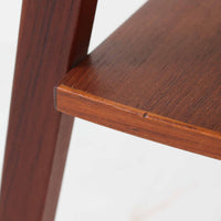 チーク材を用いたこちらの2段チェストは、緩やかにカーブした天板と舟形の引き手が特徴的な北欧ビンテージ家具です。幅64cmとコンパクトながらも引き出し2杯と下部の棚板を備え、収納力とディスプレイ性を兼ね備えています。テーパー脚が軽やかな印象を与え、ベッドサイドやリビングのサイドテーブルとしても活躍。年月を経た木肌の温かみが、空間に落ち着きと味わい深い存在感をもたらす一品です。