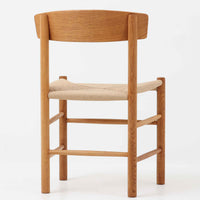 デンマークを代表するデザイナー、Borge MogensenによってFDBのためにデザインされたJ39チェアは、オーク材の丸脚と座面に丁寧に編み込まれたペーパーコードが特徴の、素朴ながらも完成度の高い北欧ビンテージチェアです。農村のキッチンチェアをルーツに持つそのデザインは、無駄を省いた潔い構造と機能美が融合し、空間に凛とした佇まいをもたらします。ダイニングはもちろん、ワークチェアやアクセントチェアとしても重宝する一脚です。