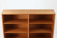 デンマークを代表するデザイナー、Borge mogensenがFDB社のために手がけたブックシェルフ。本体には上品な木目が魅力のチーク材を、土台部分には明るい色味のオーク材を採用しており、異なる材種の美しいコントラストが際立ちます。全体は無駄のないシンプルな構成ながら、細部にわたって丁寧な造り込みが施され、モーエンセンらしい機能性と静かな美しさが感じられる一台です。棚板は可動式で、本やオブジェの高さに合わせて自在にレイアウトが可能。収納力に優れつつも圧迫感のない佇まいで、リビングや書斎、寝室など幅広い空間に馴染みます。