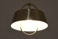 デンマークの照明ブランド、Fog & morup(フォグ&モーラップ)社によるペンダントライト「Hercules」。デザインは同社を代表するデザイナー、Jo Hammerborg(ヨー・ハーマボー)。直径41cmの存在感あるサイズに、上下を弧状に囲む真鍮製のアームが印象的な構造で、点灯時には下部のリングが光を受けて柔らかく浮かび上がります。外側はゴールドブラス、内側はホワイトで塗装されており、光の反射を美しく拡散させる仕様です。経年により一部にくすみや細かなキズが見られますが、全体としては美しい輝きを保っており、ビンテージならではの雰囲気を楽しめる一点です。E26口金のLED電球に対応し、現代の生活空間でも安心してご使用いただけます。北欧ミッドセンチュリーデザインの象徴的な一灯として、リビングやダイニングのアクセントにおすすめです。