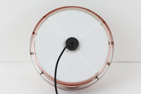 デンマークを代表する照明ブランドFog & morup(フォグ&モーラップ)社によるペンダントライト「Saturn」。デザインは同社のチーフデザイナーとして数多くの名作を生み出したJo Hammerborg(ヨー・ハーマボー)によるもの。名前の通り土星をイメージさせる円盤状のシルエットが特徴で、銅色のボディにマットブラックのバンドがアクセントとなっています。点灯時にはアクリル製のディフューザーを通して柔らかな光が広がり、上部から漏れる光が本体に陰影を与える美しい構造です。直径は34cmと空間を圧迫しないサイズ感で、ダイニングや書斎、ベッドサイドなど多用途にお使いいただけます。ボトムカバーのガラスは付属しておりませんのでご了承ください。ビンテージならではの小傷や使用感が見られますが、全体的に良好なコンディションで、モダンインテリアに映える存在感のある一灯です。