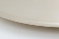 デンマークの照明メーカーLyfa社による、デザイナーEjnar B. mielby(アイナー・B・ミェルビー)が手がけた「Kuli(クーリ)」ペンダントライト。特徴的なホーン型のフォルムと、美しく仕上げられた真鍮カラーのシェードが印象的なビンテージ照明です。直径49cmと存在感のあるサイズ感で、ダイニングテーブルの上などにおすすめです。下面にはグリッド状のルーバーが備わっており、光源を柔らかく拡散しつつ眩しさを軽減する構造となっています。ソケット部分はE26口金、コードは引っ掛けシーリング仕様で、設置も簡単です。経年に伴う小傷や塗装剥がれが一部見られますが、全体としてはビンテージらしい雰囲気を保っています。空間にミッドセンチュリーのエッセンスを加える一品としておすすめです。