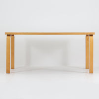 Alvar AaltoがデザインしArtek社より製造されたこちらのダイニングテーブルは、フィンランドモダニズムを象徴する一本。バーチ材の脚部に柔らかくカーブを描くLレッグ構造が取り入れられ、軽やかでありながらも高い強度を実現しています。天板は実用性に優れたホワイトラミネート仕上げで、幅150cmのゆとりあるサイズは家族での食卓やワークスペースにも最適です。幕板の一部に交換がありますが、アアルト製品が多く採用されていたデンマークの公共施設で丁寧に使用されていた個体です。