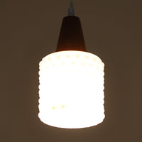 デンマーク製のペンダントライト、直径13cmです。ガラスシェードには立体的なドット模様が施され、点灯すると陰影が浮かび上がり独特の表情を生み出します。上部にはチーク材が用いられ、ガラスの繊細さと木の温もりが調和した北欧らしい意匠が魅力です。小ぶりなサイズながらも存在感があり、キッチンや廊下、ベッドサイドなど複数使いにも適しています。経年による素材の風合いがビンテージ品ならではの味わいを感じさせ、日常空間に個性を添える一品です。