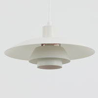 北欧より買い付けたLouis Poulsen社製「PH4」は、Poul Henningsenによる名作照明で、直径40cmの程よいサイズとアルミの軽やかな質感が魅力です。PH5と並ぶ人気を誇り、3枚シェード構造が光を柔らかく拡散し落ち着いた空間を演出します。経年の風合いも楽しめ、ダイニングやリビング、書斎や寝室まで幅広く活躍するビンテージ品です。