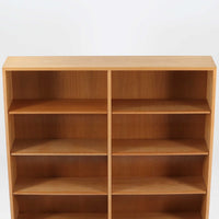 Borge Mogensenがデザインし、Karl Andersson & Sonerが製作した幅135cmのブックシェルフです。上質なオーク材を用いた無駄のない直線的な構成が特徴で、中央の仕切りにより整然とした収納を実現しています。固定棚による堅牢な構造は、日常使いの書籍や資料をしっかりと支え、空間に落ち着いた存在感をもたらします。素材の質感を活かした端正な佇まいは、リビングや書斎、オフィスにも自然に馴染み、北欧ビンテージならではの実直な美しさと経年変化の魅力を感じられる一品です。