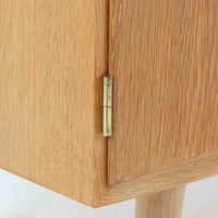 Poul Hundevadが手がけ、Hundevad & Coより製作されたキャビネットです。オーク材の端正な木目を活かしたフラットな扉構成と、細身のテーパードレッグが北欧モダンらしい軽やかさを演出します。内部は可動棚と可動式の浅型トレイを備え、書類や食器、小物まで用途に応じた整理が可能。天板下の構造や金物の収まりにも丁寧な作りが感じられ、長年の使用で深みを増した素材感がビンテージならではの魅力として空間に静かな存在感を添えます。