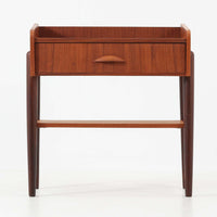 デンマーク製のサイドチェストです。チーク材ならではの温かみある木目と落ち着いた色合いが美しく、側板を立ち上げた天板形状がさりげないデザインアクセントになっています。引き出しには手掛けとして一体成形された取っ手があしらわれ、滑らかな開閉とすっきりとした正面意匠を両立しています。幅52cmの扱いやすいサイズ感で、ベッドサイドやソファ脇、玄関先などにも取り入れやすく、下段の棚板は本や小物の収納にも便利です。経年変化によって深みを増したチークの表情が、ビンテージならではの落ち着いた存在感を空間にもたらします。