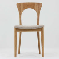 Niels Koefoedが1957年にデザインし、現在はCaso Furnitureより復刻製作されているモデル「Peter」のダイニングチェアです。オーク材の美しい木目を活かしたフレームと、背もたれに大きく設けられたアーチ状の開口部が印象的で、軽やかさと構造的な強度を両立したデザインが特徴です。身体をやさしく受け止める背のラインと、適度なクッション性を備えた座面により、日常使いにおいても快適な座り心地を実現しています。素材の質感を活かしたシンプルな佇まいは、ダイニング空間に自然と馴染み、北欧ミッドセンチュリー期のデザインらしい温かみと洗練を感じさせる一脚です。