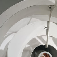 Jo HammerborgがFog & Morupのためにデザインした「Equator」は、直径40cmの存在感あるスチール製ペンダントライトで、赤・黄色・青など多彩なカラーバリエーションが展開されていたモデルとして知られますが、本品は空間に優しく溶け込む上品なホワイトカラーが採用されています。スチール特有の程よい重量感と重厚な佇まいがあり、実際に吊るすとホワイトの柔らかな印象の中にしっかりとした質感が感じられるのも魅力です。同心円状に重なるシェードが光を柔らかく分散させ、眩しさを抑えつつ立体的な陰影を生み出す構造が特徴で、ダイニングやリビングの主照明として落ち着きのあるモダンなアクセントを添えます。ミニマルな造形の中に職人技が凝縮されており、経年で深まった塗装の質感がビンテージならではの魅力を一層引き立てています。