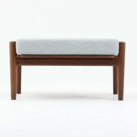 Hans J. Wegnerがデザインし、Getamaが製作したGE530オットマンです。ダークオーク材の力強い木目を活かした角の取れたフレームと、丸脚を組み合わせた端正な構造が特徴で、裏面には刻印も確認できます。程よい厚みのクッションは張り替え済みで、軽やかな生地が木部の深みのある色合いを引き立てます。同シリーズのラウンジチェアと合わせてはもちろん、単体でスツールや補助椅子としても活躍する、北欧ビンテージならではの質実剛健な一品です。