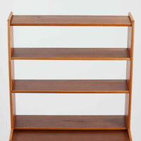 こちらのディスプレイシェルフは、チーク材とオーク材を組み合わせた柔らかなコントラストが魅力の北欧ビンテージ家具で、上部には奥行きの浅い棚板を2段備えた軽やかなディスプレイスペースに加えて天板部には引き棚が設けられており、雑貨や植物、本のレイアウトを楽しみながら作業スペースとしても活用でき、下部のスライド扉収納によって見せる収納と隠す収納を両立できるほか、細身の脚部が全体に浮遊感を与えて空間を圧迫しないバランスの良いデザインに仕上がっており、経年で深まった木肌の温もりも相まってリビングやダイニング、玄関周りにも取り入れやすい一台です。