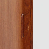 スウェーデン製のこちらのディスプレイシェルフは、チーク材の深みある木目が美しい上段のオープン棚と、下段のスライド扉収納を組み合わせた機能性の高い構成が特徴で、細身のフレームや角を丁寧に面取りした滑らかなフォルムが空間に柔らかな印象をもたらす北欧ビンテージ家具です。書籍や雑貨を見せながら収納でき、下段には日用品をすっきりと隠してしまえるため、リビングやダイニングの整理にも便利で、経年によって深まったチーク材の風合いがインテリアに温かみと落ち着きを添える一台です。