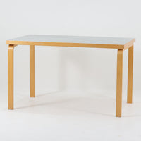 Alvar Aaltoがデザインし、Artekが製作したモデル81Bのダイニングテーブルです。バーチ材の柔らかな木肌と、アアルトを象徴するLレッグの曲木構造にリノリウム天板を組み合わせた、北欧モダンを代表するタイムレスな一台。幅120cmの使いやすいサイズは4人掛けのダイニングテーブルとしてはもちろん、書斎やワークスペースのデスクとしても取り入れやすい設計です。経年によって深みを増した木部の艶やかな表情と、使い込まれた天板の落ち着いた風合いがビンテージならではの魅力を高め、Artekオリジナルの希少性と普遍的なデザイン美が空間に上質な存在感をもたらします。