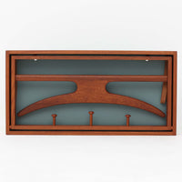 Adam Hoff & Poul Ostergaardがデザインし、Virum Mobelsnickeriにより製作された「The Hanger」ハンガーラックです。チーク材の温かみある木目と、優雅な曲線を描くベースのフォルムが印象的なデザイン。内部にはフックが備えられ、コートや帽子などを掛けて収納できます。フロントのフラップを開くとハンガー部分が現れる機能的な構造で、使用しないときはすっきりとした壁面収納として美しく収まります。革ベルトによる固定や細部の造りにも職人技が感じられる、北欧ビンテージならではの洗練された一品です。