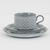 デンマークを代表するデザイナー、イェンス・H・クイストゴーによる「Cordial(コーディアル)」シリーズのヴィンテージ・トリオセット(ティーカップ、ソーサー、プレート)です。1960年代にKronjydenから制作が始まったシリーズは、その後Nissen、Bing&Grondahlと引き継がれ長く愛されたシリーズとなりました。淡いグレーのストーンウェアにハートを連想させる繊細な型押し模様が施されており、デンマークではスウェーデンやフィンランドの陶器メーカーと並んで今でも非常に人気のある商品となります。