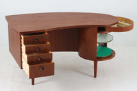 「カイ・クリスチャンセン」デザインの1950~1960年頃に作成されたキドニーシェイプ(腎臓型)のデスクです。良質なチーク材が使用されており、蛇腹のバーキャビネット、背面のバックシェルフ、天板の形状など非常に凝ったデザインでどの角度から見ても素敵で北欧家具ならではの雰囲気です。お部屋の真ん中に置いてお楽しみください。現在、現地でも数が少なく価格が非常に高騰しています。今回入手出来たこちらのデスクは状態も良いので、この機会に是非ご検討ください。