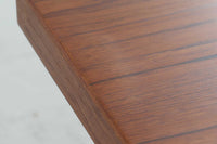 "No42"や"ペーパーナイフ"で有名なカイ・クリスチャンセンのデザインによる、円形のダイニングテーブルです。天板の縁は角が落とされて丸みを帯びており、全体的に柔らかい印象に仕上がっています。良質なチーク材が使用されています。急な来客時にも対応できるエクステンションタイプです。拡張板が2枚付属します。デンマーク家具で良く見られる構造ですが、拡張板の仕様が1枚はチーク材、もう1枚は材質が不明(幕板が無い物)です。サービス品とお考えください。