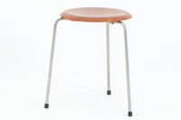 1954年、デンマークのデザイナー、Arne Jacobsen(アルネ・ヤコブセン)によって発表された3本脚のスツール、「DOT(ドット)」。このスツールは、ヤコブセンが手がけた「ルードブレ市庁舎」のロビーで待合席として使用されていました。1970年には4本脚のバージョンも登場しましたが、3本脚のモデルは同年に廃盤となり、現在はビンテージ品のみで入手可能です。オフィスや自宅での日常的な使用はもちろん、予備の椅子としても便利なこのスツールは、シンプルなデザインが魅力です。座面の中央がわずかにくぼんでおり、座った際にフィット感を生み出します。シンプルながらもヤコブセンのこだわりが感じられ、また、単なるスツールとしてだけでなく、ソファの横に置いて本や小物を置くサイドテーブルとしても活用できます。座面裏には薄っすらとFritz Hansen社の刻印がございます。