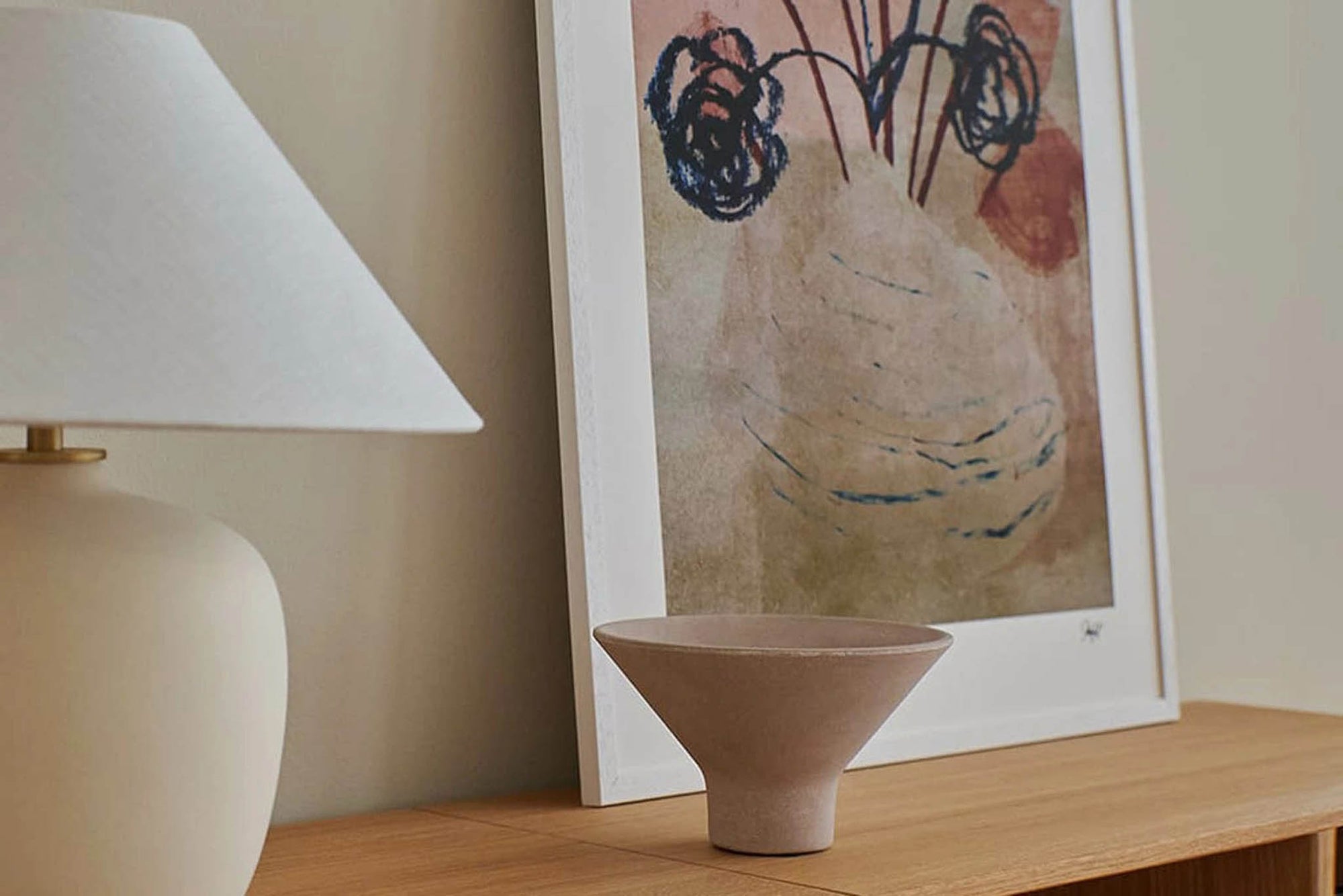 スカンジナビアのクラフトマンシップにインスパイアされた、北欧デザインの美学が息づく天然木製のポスターフレーム。温もりある無垢材と洗練されたスリムなフォルムが融合し、アートポスターや写真をすっきりと引き立てながら、空間全体に落ち着きと上質さをもたらします。上質な天然木を使用したフレームは、不透明ながらも木目の自然な表情をほのかに感じさせ、ナチュラルでありながら現代的な雰囲気も演出します。金属製のハンガーが裏面に取り付けられており、縦横どちらの向きでも壁に掛けてご使用いただけます。アルミフレームにはない自然素材ならではの豊かな質感とぬくもりは、北欧諸国でも高く評価され、定番のインテリアアイテムとして広く親しまれています。シンプルで飽きのこないデザインは、ミニマルインテリアやナチュラルテイストのお部屋にも自然に調和し、日常に木の優しさと北欧らしい上質な空気を添えてくれます。