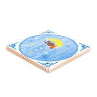 StoryTiles（ストーリータイル）は、オランダ・アムステルダム発のセラミックタイルブランドです。デザイナーMarga van Oersが、古いデルフトタイルに現代的なイラストを重ねたことから誕生しました。伝統的なオランダのタイル文化を受け継ぎながら、動物や人物、風景などをユーモアと物語性のある表現で描いたデザインは、壁に飾る小さなアートピースとして世界中で親しまれています。タイルはオランダ国内の窯で丁寧に焼き上げられ、セラミックならではの質感と釉薬の艶やかな表情が魅力です。紙のポスターとは異なる陶器の重厚感があり、リビングや玄関、キッチンなどに一枚飾るだけで空間に個性と彩りを添えてくれます。北欧インテリアやヨーロッパのヴィンテージ家具とも相性が良く、壁掛けアートやインテリア雑貨を探している方、記念日や新築祝いのギフトにもおすすめのブランドです。