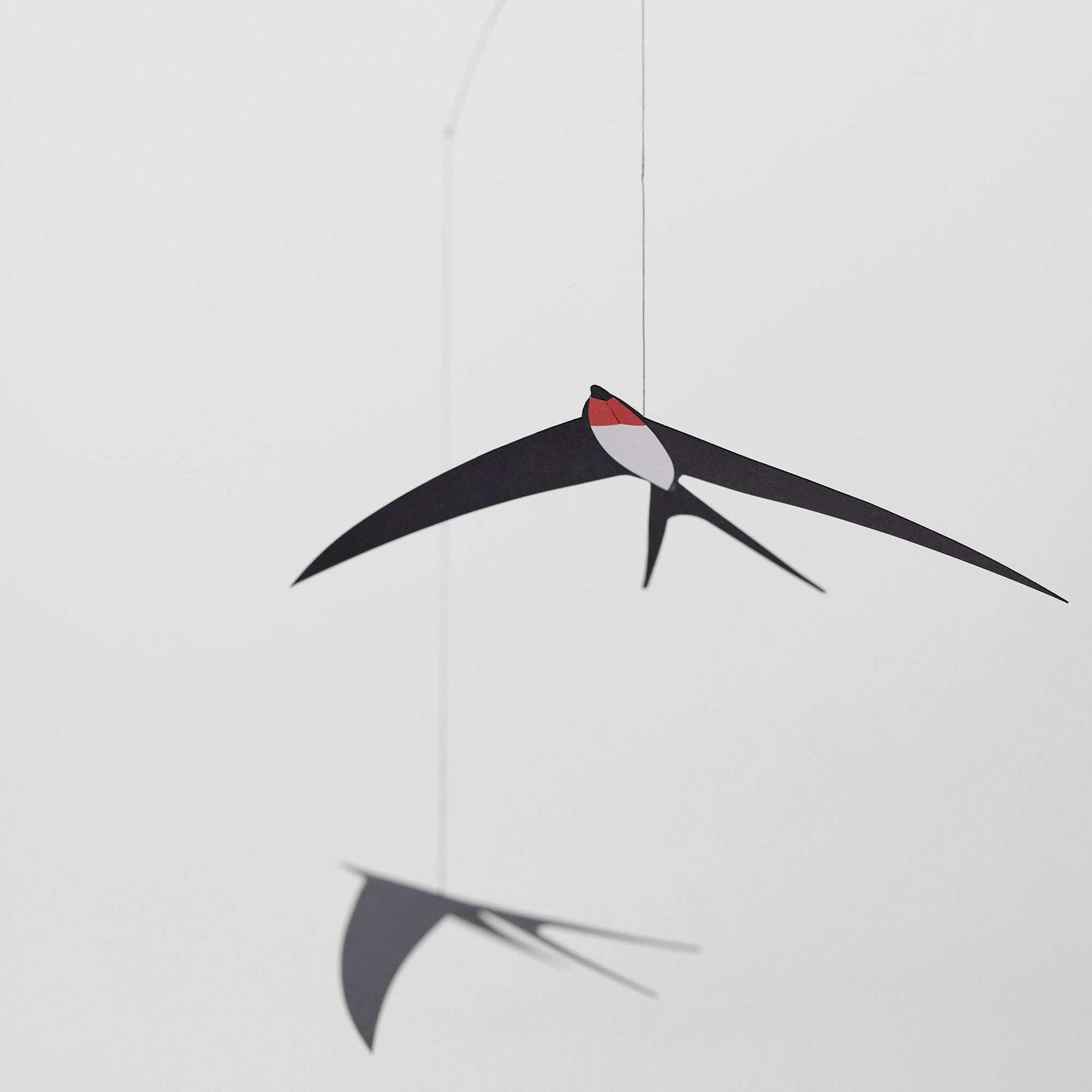 Flensted Mobiles（フレンステッド・モビール）は、1953年創業のデンマーク発・モビール専門ブランド。北欧デザインの文脈に立脚し、造形・質量配分・回転慣性を最適化して、わずかな気流でも自律的に表情を変える構成美を追求します。各パーツは重心とトルクの釣り合いを精密に設計し、静止と運動のあいだを往還する“動く彫刻”として空間に時間軸を付与。代表作「Lucky Storks」から幾何学、鳥類、気球まで多彩で、紙・ステンレス・木材の軽量構造は施工負荷が小さく、住宅・商業・ホスピタリティ・キッズ空間に適合します。現在もデンマーク国内で手作業組立・品質管理を徹底し、視覚ノイズを抑えた運動リズムが集中・鎮静・遊び心をもたらします。北欧インテリアの天井飾りや吊り下げモビールとして、リビング・子供部屋・出産祝いギフトに最適なデンマーク製の正規品です。