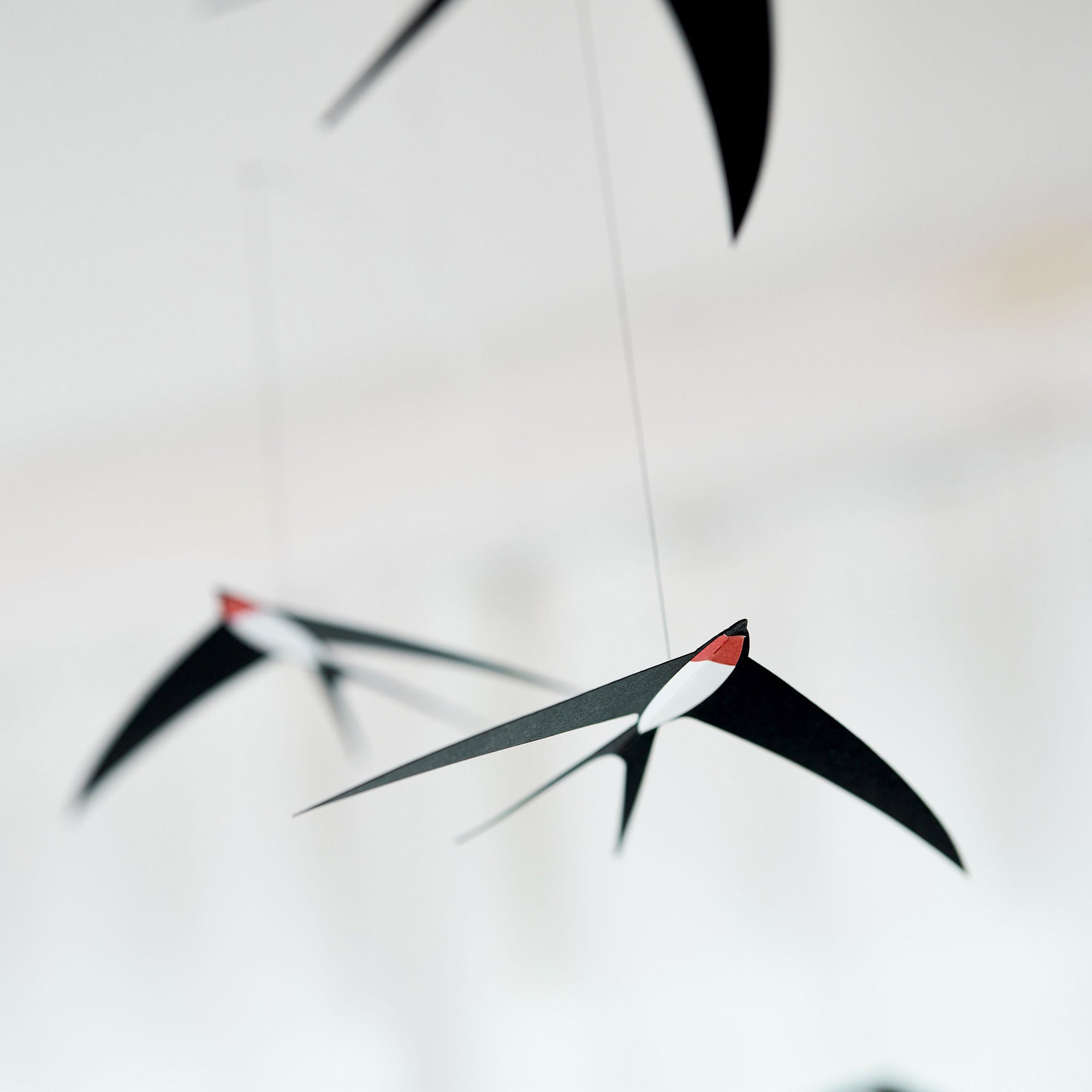 Flensted Mobiles（フレンステッド・モビール）は、1953年創業のデンマーク発・モビール専門ブランド。北欧デザインの文脈に立脚し、造形・質量配分・回転慣性を最適化して、わずかな気流でも自律的に表情を変える構成美を追求します。各パーツは重心とトルクの釣り合いを精密に設計し、静止と運動のあいだを往還する“動く彫刻”として空間に時間軸を付与。代表作「Lucky Storks」から幾何学、鳥類、気球まで多彩で、紙・ステンレス・木材の軽量構造は施工負荷が小さく、住宅・商業・ホスピタリティ・キッズ空間に適合します。現在もデンマーク国内で手作業組立・品質管理を徹底し、視覚ノイズを抑えた運動リズムが集中・鎮静・遊び心をもたらします。北欧インテリアの天井飾りや吊り下げモビールとして、リビング・子供部屋・出産祝いギフトに最適なデンマーク製の正規品です。