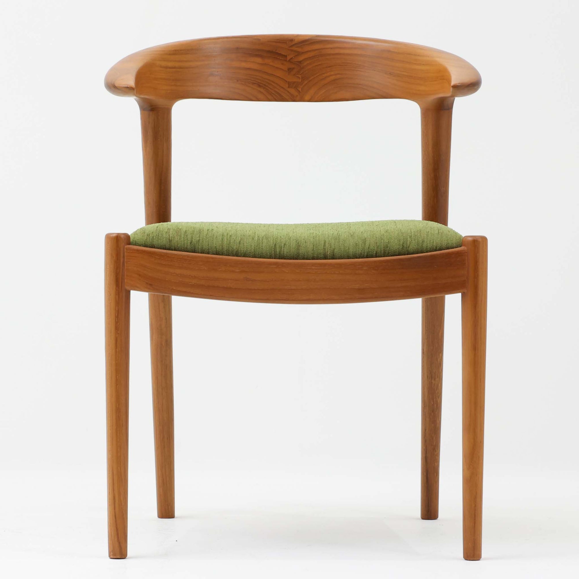 北欧スタイルのアームチェアです。人気のCF-2040をリデザインして作りました。短くなったアームはより機能的で、肘置きとしては十分使用できゆったりと座っていただけます。また、テーブルへ座面半分程度を収納することができるのも特徴です。アーム部の木目を綺麗に見せるために背もたれ中央でジョイントしたり、全体のバランスを取るために脚それぞれの角度を傾けたりなど細かいところまでデザインされています。