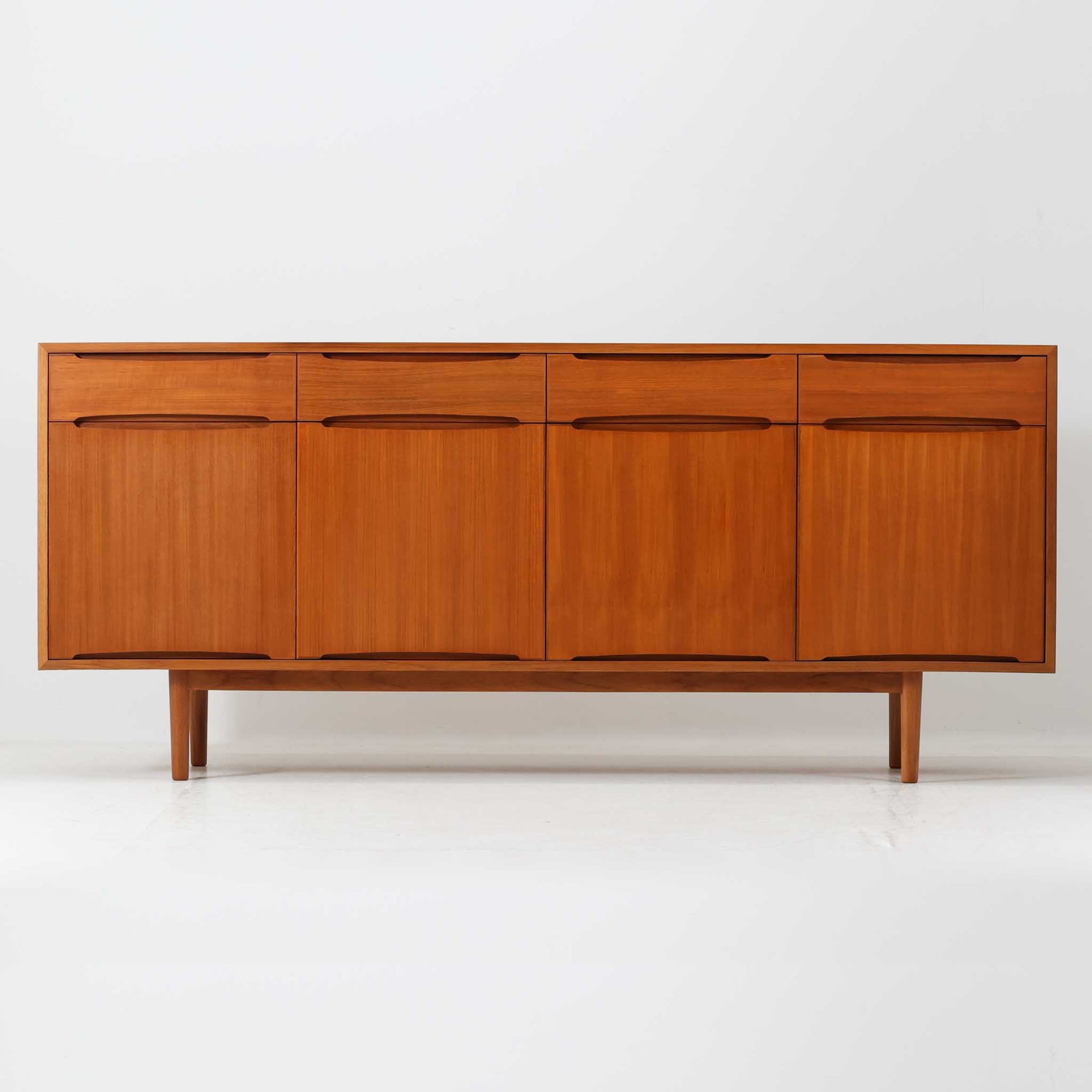 北欧モダンスタイルのワイドキャビネットです。取っ手を葉っぱの形に削りだしているのが特徴的なデザインです。上部には引出収納を４つ、下部には扉収納を２つ備えています。下部収納部の棚板は高さ調整可能、取り外しも可能です。使い勝手も良好で、収納時見た目にも大変上品で美しい雰囲気があります。素材は脚も含め全てチーク材を使用しており、美しい暖かな風合いの木目が心地よさを演出します。少し小さめなのがお部屋を圧迫することもなくおしゃれに演出することが可能です。