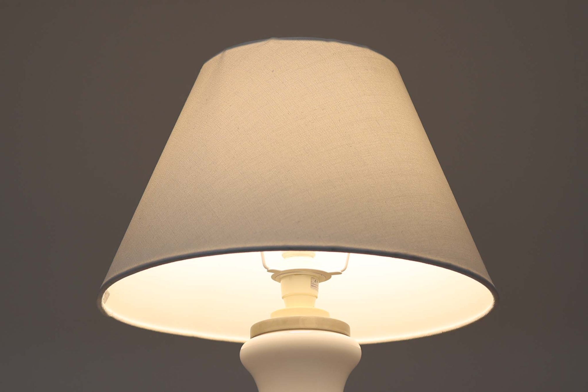 著名なデザイナー、Sidse Werner（シセ・ヴェルナー）による「BIBLIOTEK」のテーブルランプです。ペンダントランプはよく見かけますが、テーブルランプは非常に珍しいモデルです。ホルムガードならではの厚みのある高品質なガラスを使用しており、点灯するとシェードを通して柔らかな温かみのある光が広がり、空間を優雅に照らします。高さ64cmの大型サイズで存在感があり、リビングや書斎、ベッドサイドなど、あらゆるインテリアに美しく調和します。