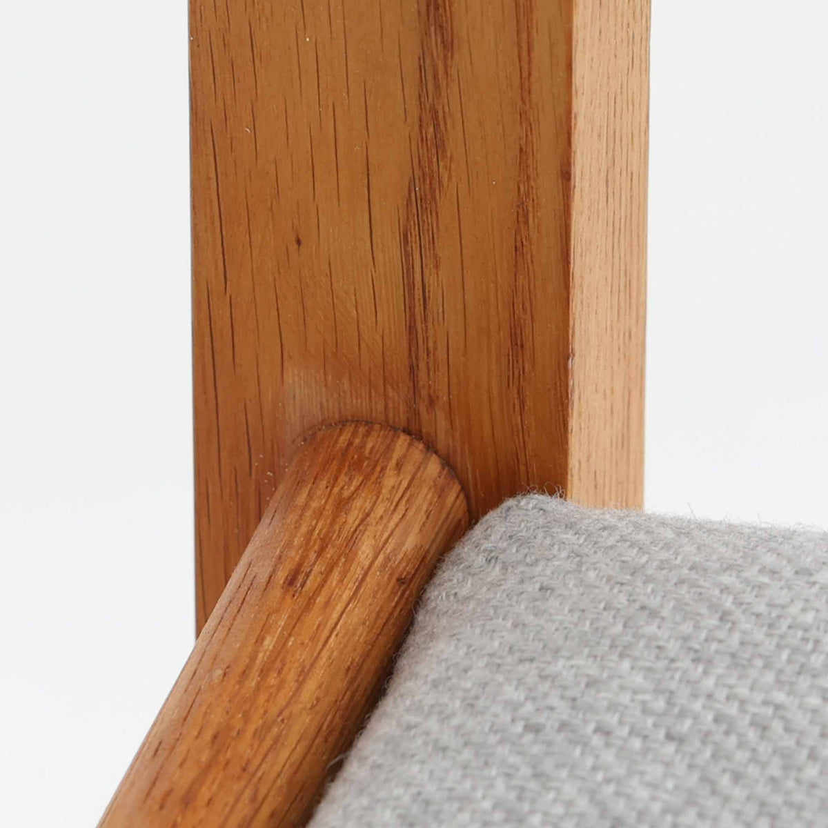 Hans J. Wegner（ハンス・J・ウェグナー）がデザインし、Getama（ゲタマ）が製造を手掛けたGE151アームチェアです。オーク材による直線的で端正なフレームに、ゆるやかにカーブした背もたれと座面を組み合わせた、軽快で機能的な佇まいが魅力。幅のあるアームは木の質感を存分に感じられ、長年の使用による風合いもビンテージならではの味わいです。ダイニングや書斎のほか、ゆったりと腰掛けるラウンジチェアとしても取り入れやすい一脚です。