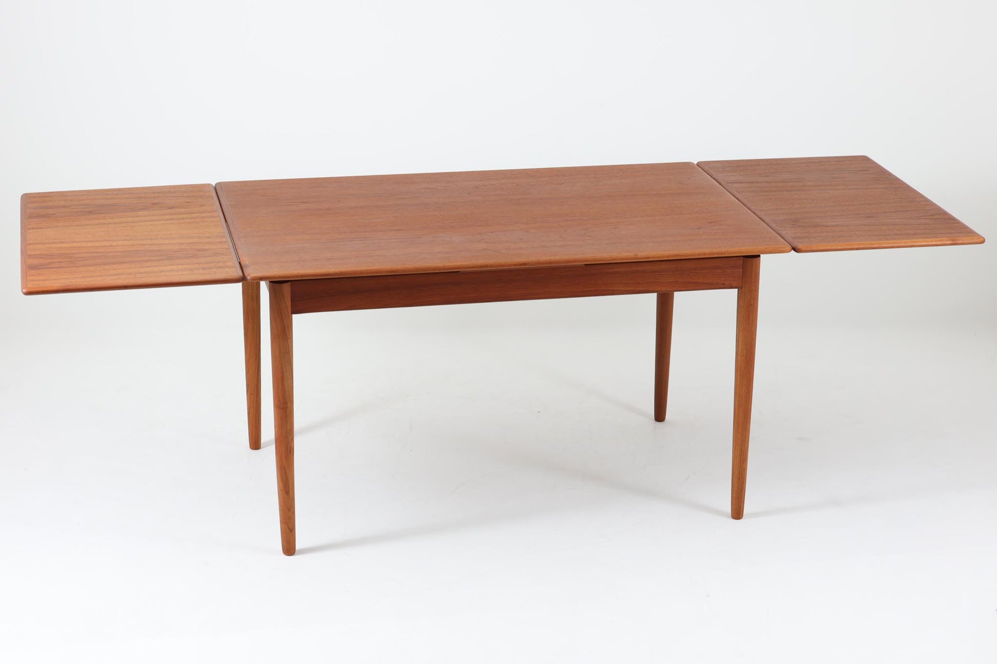 北欧より買い付けたエクステンションダイニングテーブルです。良質なチーク材が使用されており、その美しい木目が際立っています。天板は用途に応じて簡単に広げることができ、非常に便利です。また、片側のみ拡張板を広げて使用することも可能です。少し使用感が見受けられますが、価格にはその点を考慮しています。メンテナンスが施されており、全体的に綺麗な状態です。