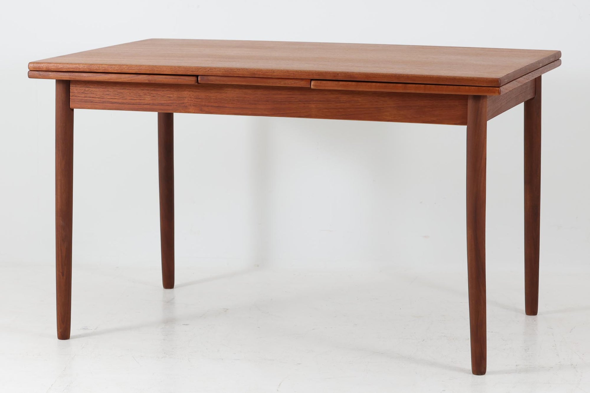 北欧から買い付けたエクステンションダイニングテーブルです。良質なチーク材が使用されており、美しい木目が際立っています。天板は使用目的に応じて、簡単に広げることができるため、非常に便利です。片側のみ拡張板を広げて使用することも可能です。幅120cmのコンパクトで珍しいサイズ感が特徴です。脚の1本にわずかな反りがございますが、無垢材が使用されているため、自然な風合いとしてご理解いただけますようお願い申し上げます。