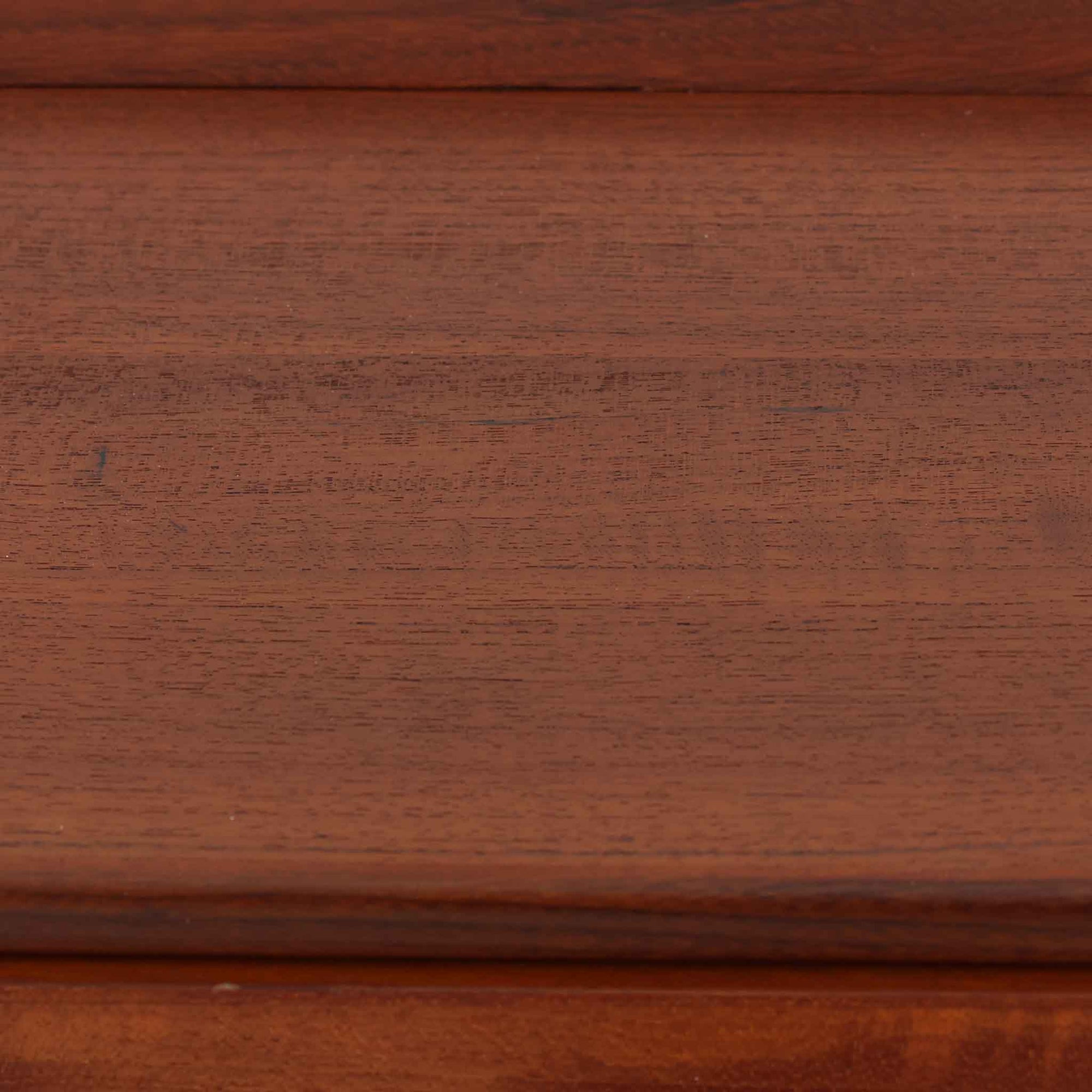 デンマーク製ライティングビューロです。上段には小引き出しと仕切り棚、中央には小さなミラーが備わり、書き物や身支度など多用途にお使いいただけます。チーク材の深みある色合いと滑らかな木目が美しく、シンプルで直線的なフォルムが落ち着いた印象を与えます。引き出しの斜めに削り出された取っ手やテーパー脚など、北欧らしい洗練されたディテールが魅力です。経年により増した艶が味わい深く、リビングや寝室に上品な温もりを添える一台です。