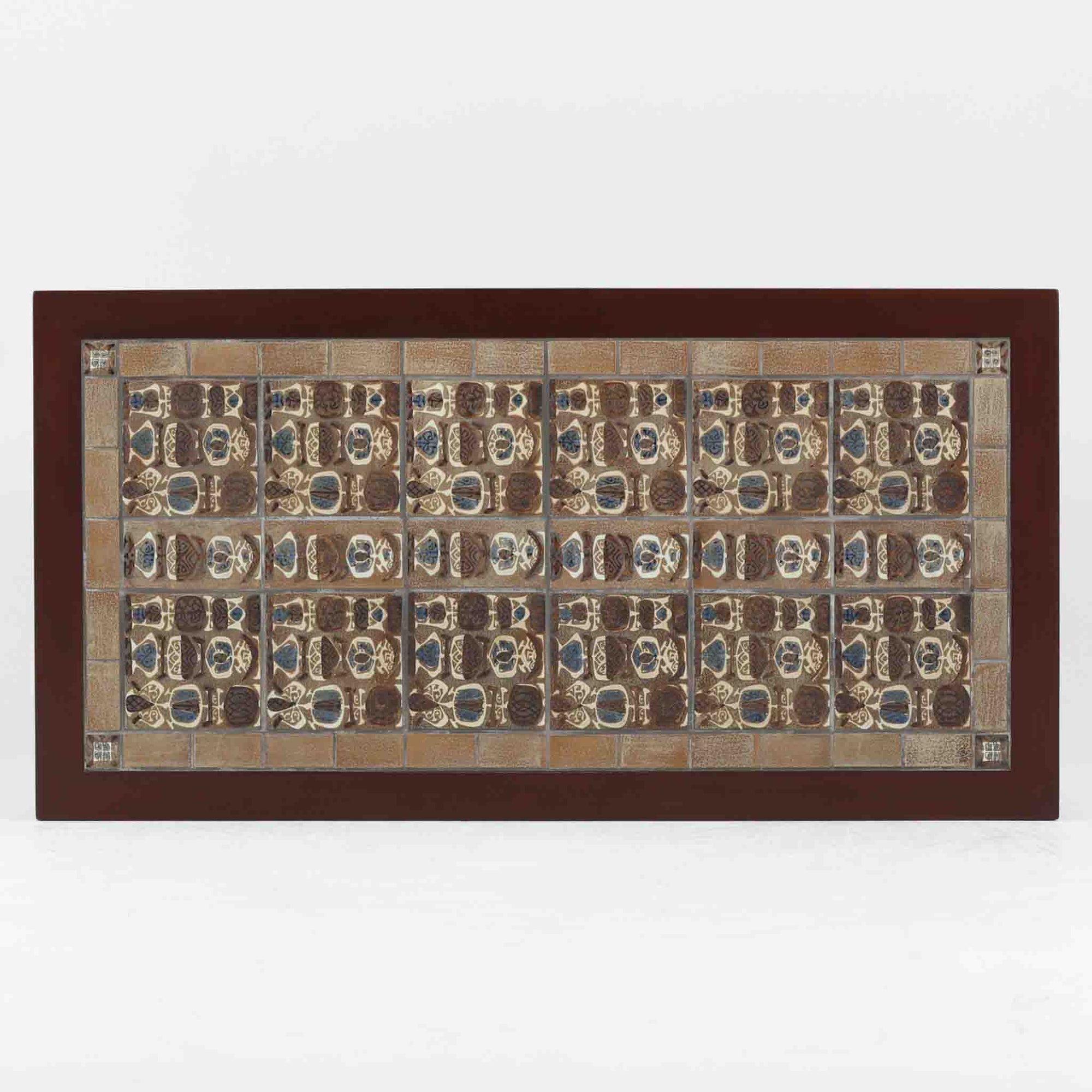 Nils Thorssonがデザインを手掛け、Royal CopenhagenのBACAシリーズのタイルを天板に配したセンターテーブルです。家具メーカーHaslev社により製作され、マホガニー材の落ち着いた木目と、幾何学的で温かみのあるタイル意匠が美しく調和しています。直線的で端正なフォルムは空間をすっきりと見せ、リビングの主役としてはもちろん、ソファ前のローテーブルとしても活躍。経年により深みを増した木部と味わい豊かな陶板が、北欧ビンテージならではの存在感を放つ一品です。