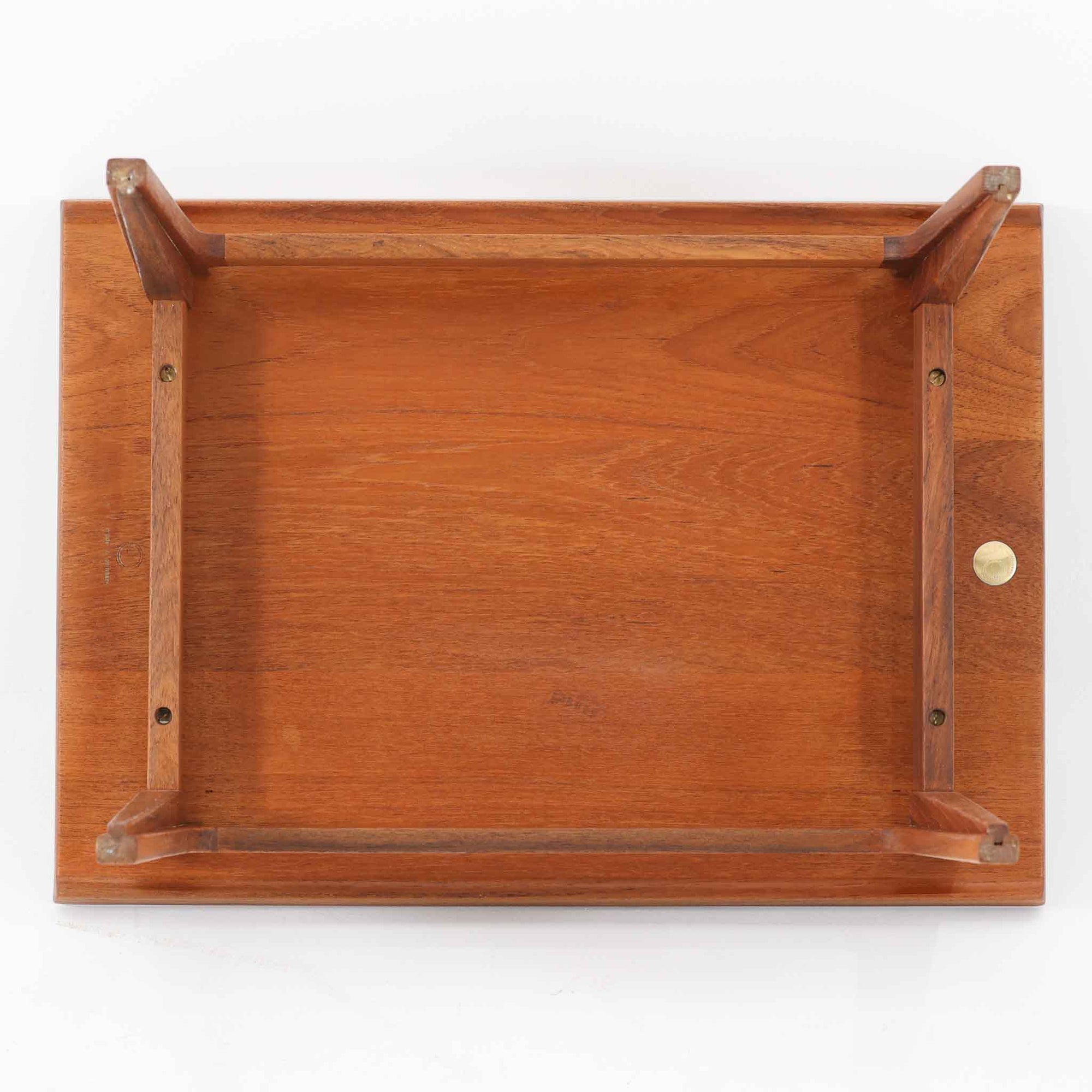 デンマークの巨匠フィン・ユールによるデザイン、France &amp; Son社製のサイドテーブル「FD635」です。ロゴより1957年頃に製造されたと推測される本品は、チーク無垢材を贅沢に使用し、滑らかな脚部の曲線と柔らかなエッジラインが見事に調和した美しいデザインが魅力です。天板の縁にはわずかな立ち上がりが設けられ、機能性と造形美を兼ね備えた構造となっています。彫刻的ともいえる有機的なフォルムはフィン・ユールの真骨頂であり、リビングやベッドサイドで北欧家具の上質な存在感を引き立てる逸品です。