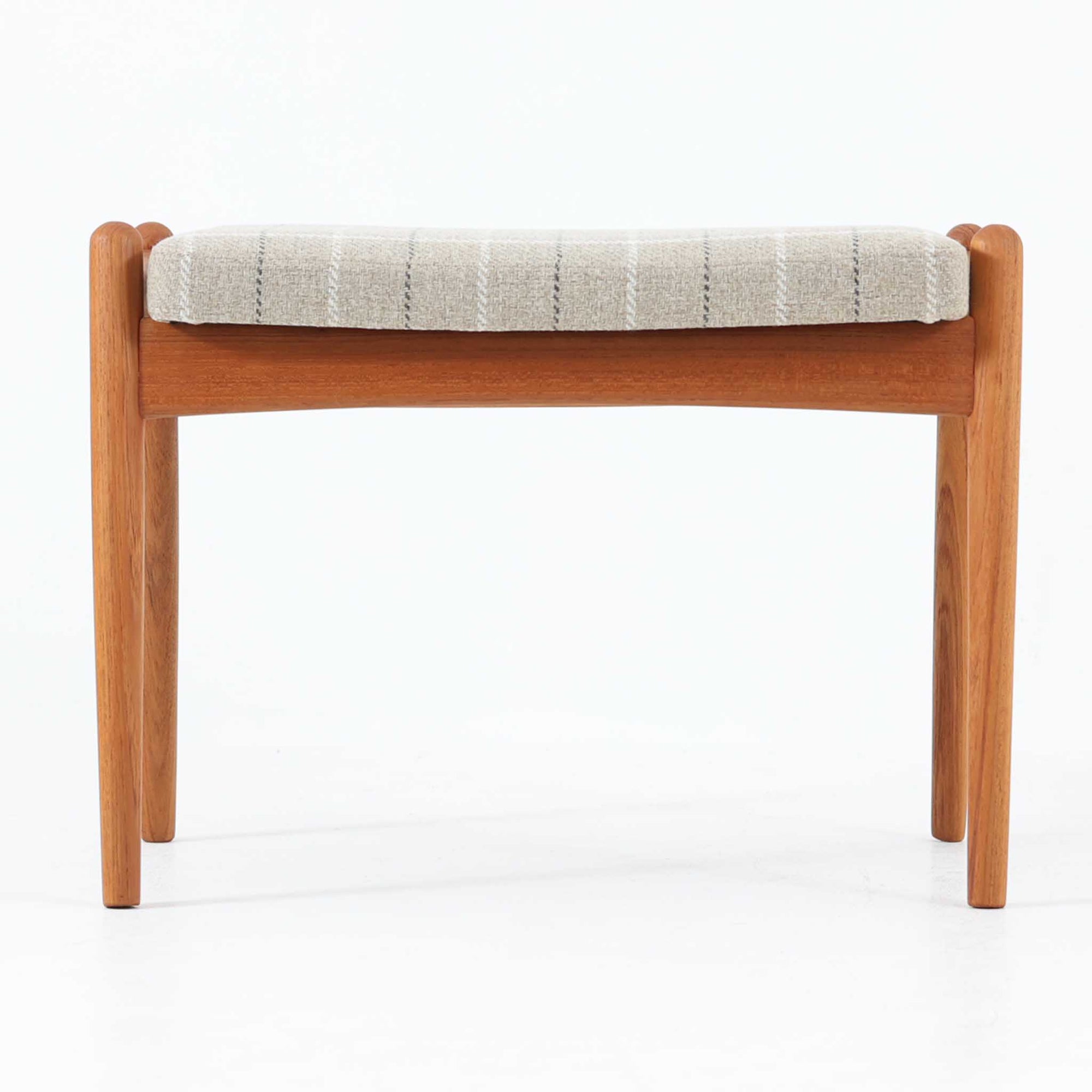 北欧デンマーク製のこちらのスツールは、チーク材のフレームにチェック柄のファブリックを組み合わせた温かみのある佇まいが魅力です。座面裏にある金具により角度調整が可能な珍しい仕様で、オットマンとしてだけでなく、ちょっとした腰掛けや足置きとしても柔軟に活躍します。コンパクトながらも曲線を活かしたデザインと堅牢な造りが、ビンテージらしい味わいと使い勝手の良さを兼ね備えています。