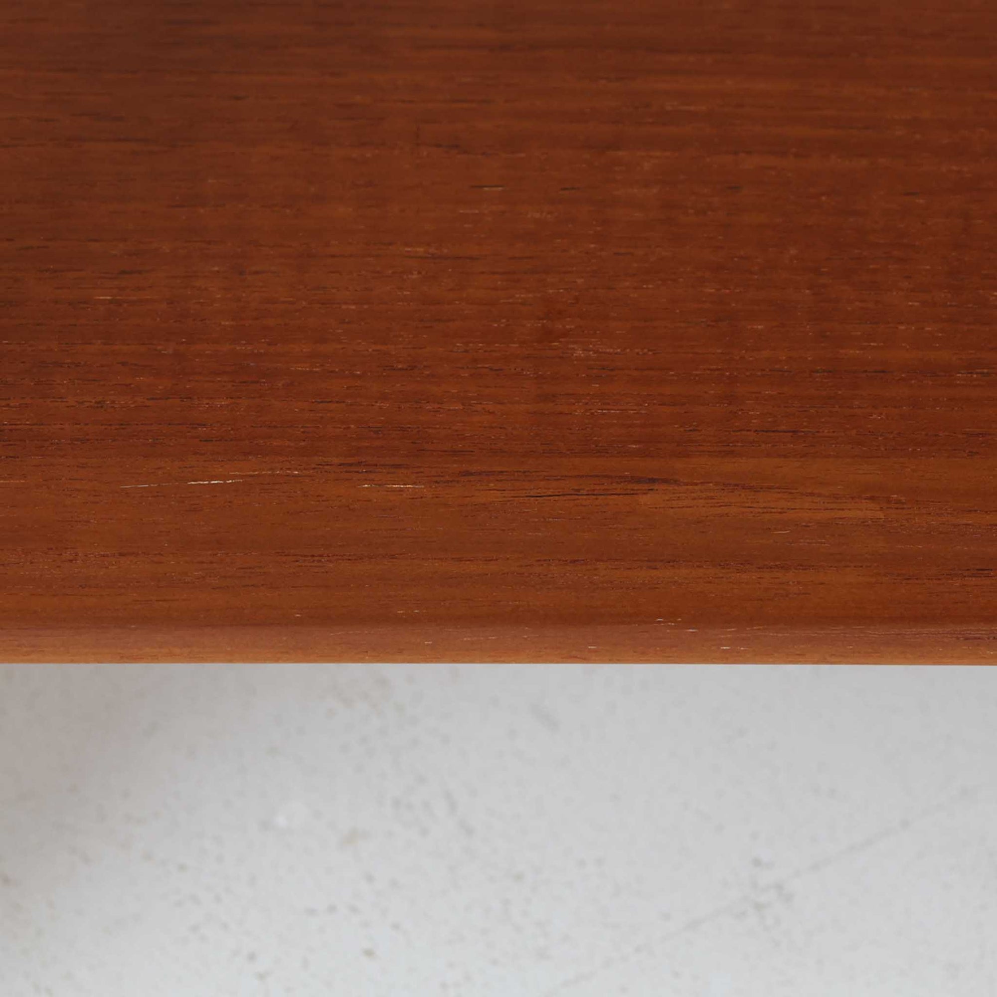 Hans J. Wegnerがデザインし、Andreas Tuck社から発表されたAT33ソーイングテーブルは、チーク無垢材を贅沢に用いた希少なモデルです。両側のバタフライ式天板で作業スペースを拡張でき、仕切り付きの引き出しとラタン製バスケットが裁縫道具や小物を美しく収納します。下段の棚板も備えた実用性の高い構造で、繊細な造作と職人技が光る北欧ビンテージ家具の逸品です。