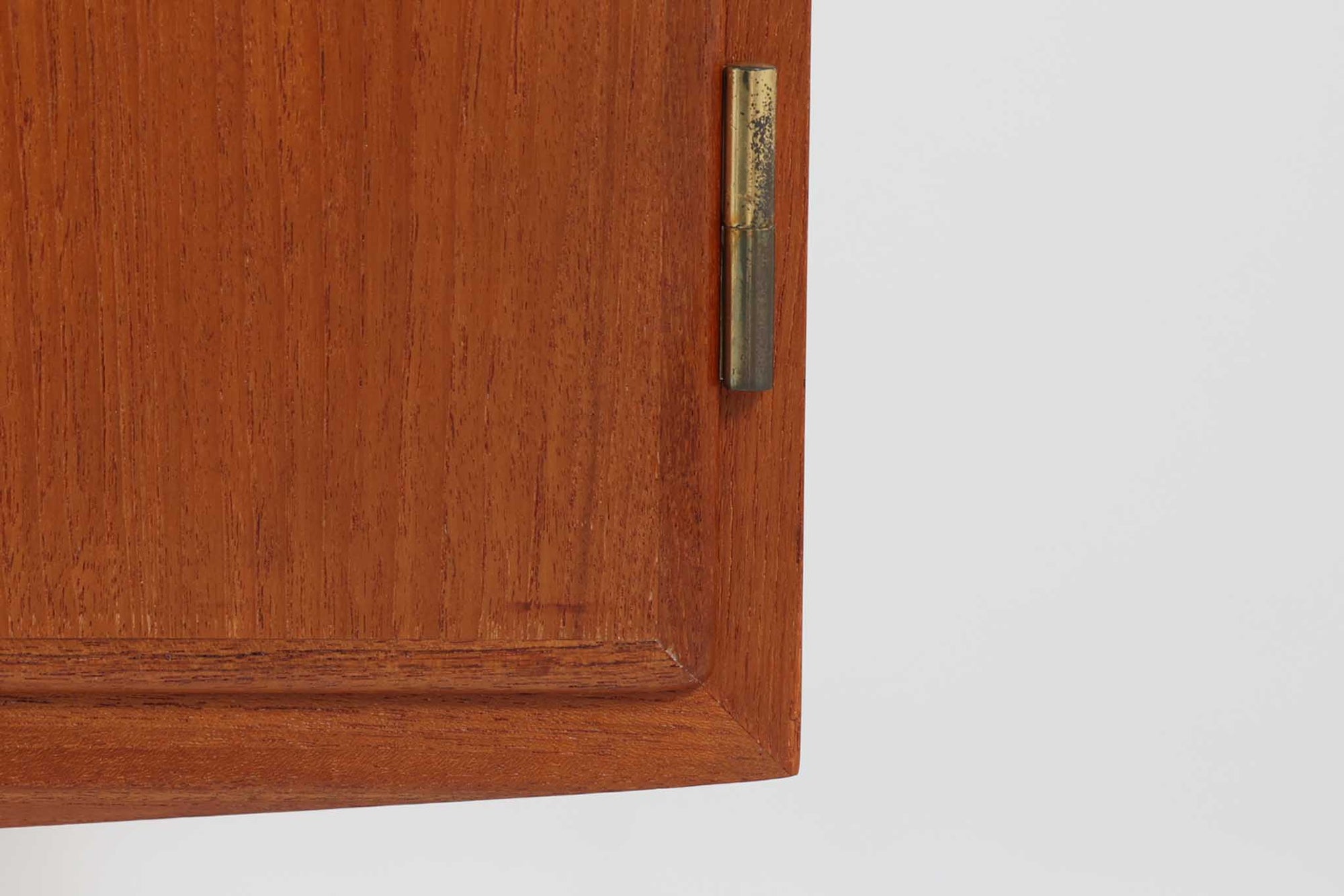 デンマークの家具メーカーHundevad &amp; Co（ハンデバッド）による、Poul Hundevad（ポール・ハンデバッド）デザインのビンテージキャビネットです。美しい木目のチーク材が贅沢に使用され、北欧らしいシンプルで洗練された印象を与えます。両開きの扉内には左側に浅いトレイ状の引き出しが4段、右側には可動棚が2枚設けられており、機能性と収納力に優れた設計。扉の錠前は破損していたため施錠は出来ません。扉の開閉はボールキャッチ方式となっております。鍵は扉開閉用の取っ手として使用します。脚部にはすっきりとしたテーパードレッグが採用され、軽やかで洗練された佇まいが魅力です。リビングやダイニングなど幅広い空間で活躍する一台です。