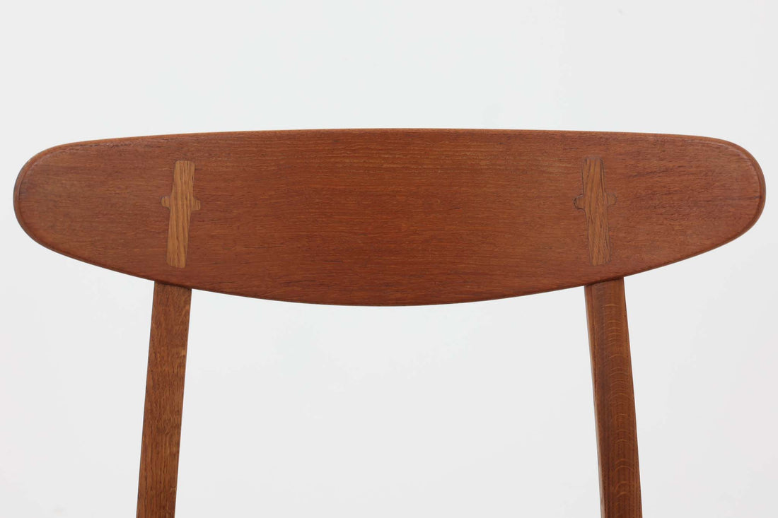 CH30は、ハンス・J・ウェグナーがデザインし、Carl Hansen & Son社によって製造された名作ダイニングチェア。チーク材とオーク材を組み合わせた美しいコントラストが特徴で、木の温もりと洗練されたフォルムが魅力です。特に背もたれと後ろ脚の繋ぎ目は、そのデザインの特徴となっており、独自性とクラフトマンシップの見本と言えるでしょう。背もたれにチーク材が使用された希少なモデルです。人気のため現在復刻されましたが、チーク材とオーク材の組み合わせはビンテージ品でのみ入手可能です。