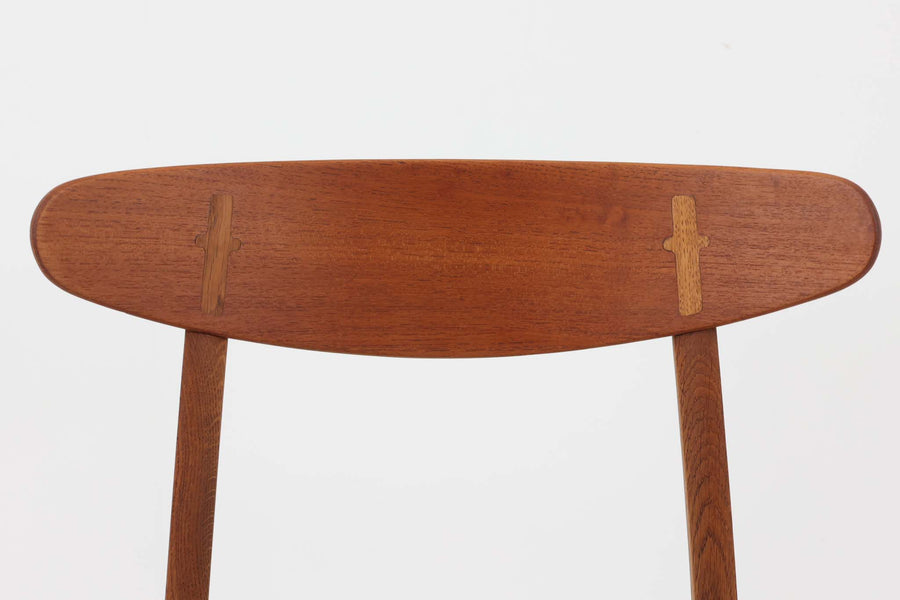 CH30は、ハンス・J・ウェグナーがデザインし、Carl Hansen & Son社によって製造された名作ダイニングチェア。チーク材とオーク材を組み合わせた美しいコントラストが特徴で、木の温もりと洗練されたフォルムが魅力です。特に背もたれと後ろ脚の繋ぎ目は、そのデザインの特徴となっており、独自性とクラフトマンシップの見本と言えるでしょう。背もたれにチーク材が使用された希少なモデルです。人気のため現在復刻されましたが、チーク材とオーク材の組み合わせはビンテージ品でのみ入手可能です。